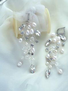 "Pearl Crystal Bridal Earrings Pearl Crystal Wedding Earrings Pearl Rhinestone Silver Earrings Crystal Long Earrings These beautiful earrings are truly stunning and would add a romantic touch to any women's ensemble! Made from high-quality crystals, pearls and beads they glisten and catch the light beautifully, whilst remaining classy, chic, and understated. These earrings are extremely romantic! The color of the wire and elements can be changed on request. Description: -- Width earrings 3cm / 1 Silver Sparkling Clip-on Earrings For Wedding, White Chandelier Earrings With Sparkling Stones For Anniversary, White Cubic Zirconia Cluster Earrings For Wedding, Anniversary White Chandelier Earrings With Sparkling Stones, Sparkling Pearl Earrings For Gift, Wedding Crystal Cluster Earrings With Sparkling Stones, Sparkling Dangle Clip-on Earrings For Wedding, Wedding Cluster Earrings With Sparkling Crystal Stones, White Sparkling Bridal Earrings For Anniversary