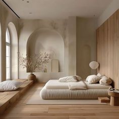 a large bed sitting in the middle of a bedroom next to a tall wooden wall