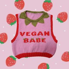 a pink sweater with the words vegan babe on it and strawberries all around