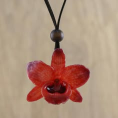 Local Thai artisans carefully select a natural orchid flower ensuring its quality. The beautiful flower is preserved through a painstaking electroplating process which coats it in shining resin to display its dyed ruby hues. Adorning the neck on a length of espresso leather cord this pendant necklace features an adjustable length with sliding glass beads at the clasp. Unique Orchid-colored Jewelry As A Gift, Unique Orchid-colored Jewelry Gift, Unique Orchid Colored Jewelry For Gift, Unique Orchid Jewelry For Gift, Orchid Flower Necklace For Gift, Orchid Necklace, Dope Jewelry, Funky Jewelry, Jewelry Lookbook