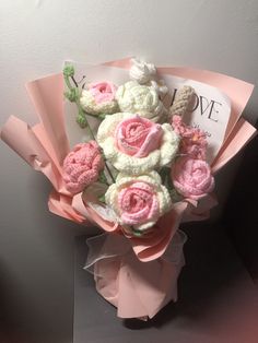 a bouquet of pink and white crocheted flowers