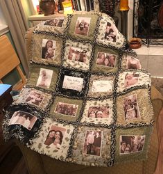 a blanket with pictures on it sitting on a chair in front of a fire place