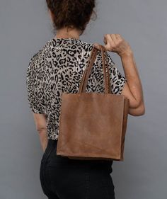 Check out other colors of this bag style here:https://www.etsy.com/shop/bags1and1stuff?ref=hdr_shop_menu&section_id=15504059A small leather tote to use when going out, this is what makes this bag worth purchasing for your own use. This simple leather tote is made out of leather and is sure to suit the outfit you'll be wearing for the party or any special occasion you'll be attending. Though it is small in size, this small black bag is sure to maximize your look as it is able to give the best Plain Tote, Money Smart, Trendy Tote Bags, Simple Leather, Fashion Tote Bag, Small Tote Bag, Brown Tote, Brown Handbag, Evening Handbag