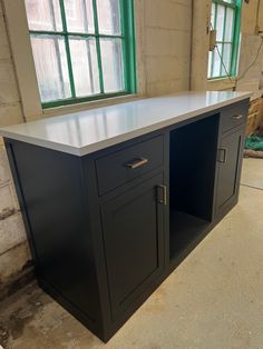 a kitchen island in the middle of an unfinished room