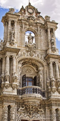 an ornate building with statues on the outside