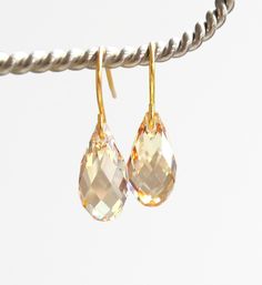 These simple elegant earrings are in the light gold shade of Golden Shadow by Swarovski Crystal. I have attached the sparkling gems to plated ear wires. The briolette measures 13mm for a total length of about an inch. Copyright ©, all rights reserved. LoveYourBling® is an authorized SWAROVSKI® Crystals Branding Partner. Gold Briolette Crystal Earrings For Wedding, Gold Crystal Teardrop Earrings, Gold Briolette Teardrop Earrings With Pearl Drop, Gold Briolette Teardrop Earrings For Wedding, Gold Crystal Teardrop Drop Earrings, Gold Briolette Crystal Earrings With Ear Wire, Gold Teardrop Crystal Earrings, Gold Teardrop Hypoallergenic Crystal Earrings, Gold Hypoallergenic Drop Crystal Earrings