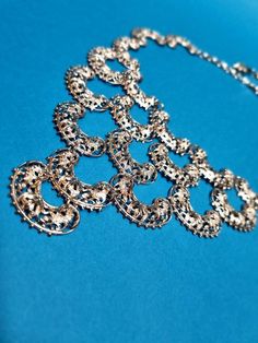 This highly collectible 1970's Vendome bib necklace is in excellent vintage condition. It has an expensive look, and a lightweight feel. It features filigree curved discs, which have been individually linked together, by hand. The craftsmanship is exquisite. Adjustable to 41.5cm. The bib part measures approx 13cm x 9.5cm. Each disc measures 2.9cm x 1.7cm. The hook is signed Vendome. The matching earrings are for sale here >> bit.ly/VendomeFiligreeEarrings. -------------------- 🌟 P&P: 👉 Will ar Expensive Look, Bib Necklaces, 70s Vintage, Bib Necklace, Matching Earrings, Vintage Silver, Diamond Bracelet, Necklace Etsy