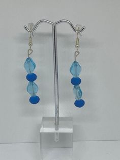 Material: Bracelet: Clear string Earrings: Metallic Color; Light blue Pearls with dark blue pearls Type: earrings and Bracelet Style: Glamorous Elegant Blue Round Bead Jewelry, Elegant Blue Jewelry With Faceted Beads, Elegant Aquamarine Blue Jewelry, Elegant Blue Aquamarine Jewelry, Light Blue Faceted Beads Elegant Jewelry, Blue Dangle Jewelry For Formal Occasions, Elegant Blue Faceted Beads Earrings, Elegant Light Blue Jewelry With Faceted Beads, Blue Faceted Beads Jewelry For Wedding