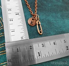 This listing is for a personalized safety pin charm necklace. The leather cord is adjustable with sliding knots - one size fits most! You'll be able to choose your chain length and style from the drop-down menu. Keyrings, link chains, bangle bracelets, and ball chains are also available. :) You can add on an initial charm for $3.00. **Please see the second photo for scale. The initial charm measures 5/16 inch. For more details on item size, please see the secondary photos or write us for measure Personalized Adjustable Metal Charm Necklaces, Personalized Adjustable Metal Charm Necklace, Personalized Metal Jewelry For Everyday Use, Adjustable Charm Necklace For Personalized Gift, Charm Necklaces With Adjustable Chain For Personalized Gifts, Adjustable Metal Charm Necklaces For Personalized Gifts, Safety Pin Necklace, Safety Pin Bracelet, Brown Leather Necklace