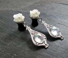 "These made to order elegant dangle plugs feature resin roses in your choice of color, set on silver plated scalloped settings. Dangling from each plug is a fancy Victorian antiqued silver plated frame with swirl and floral details. The settings hold small oval clear vintage glass gems with a rainbow (AB) finish and are flat on the back. They are really lovely plugs, simple yet with an elegant touch. This pair is available in sizes 10g thru 0g, in the following styles: 12g (2mm) - Steel Screw Ba Internally Threaded White Earrings For Weddings, White Internally Threaded Earrings For Wedding, Dangle Plugs, Plug Earrings, Alternative Bride, Glass Gems, Plugs Earrings, Gauges Plugs, Plate Frames