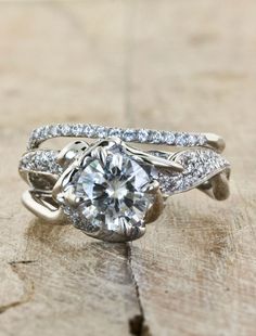 an engagement ring with a center stone surrounded by diamonds