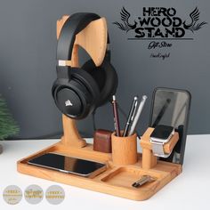 headphones and other items are sitting in a holder on a desk next to a phone