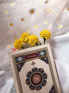 there is a card with the name of the muslim person on it next to some flowers