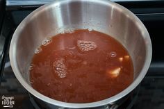 a pot filled with liquid sitting on top of a stove