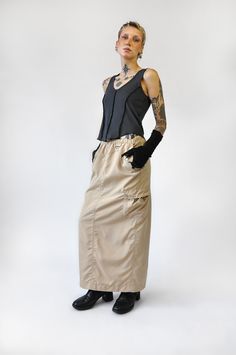 Be on the go and shielded from the elements. Cargo maxi with a parachute skirt fee. Adjustable drawstring waistband, lots of pockets made from a water resistant material. FIT NOTES:Model is 5'7, 25" waist and wears a size Small and mid/low rise look. For a lower fit size up. For a high waisted fit stay true to size100% PolyesterMade in China/Designed in USA Parachute Skirt, China Design, Cargo Skirt, Stay True, Drawstring Waistband, Low Rise, The Go, Midi Skirt, Normcore