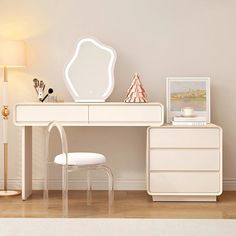 a white desk with a mirror, chair and lamp