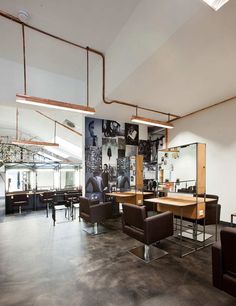 an empty restaurant with chairs and tables in the middle of it, along with pictures on the wall