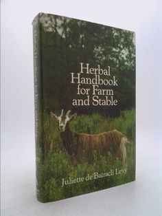 a book with an image of a goat and another animal in the grass, on a white background