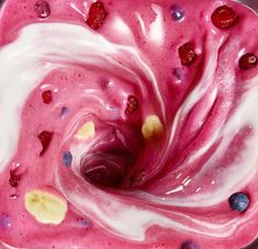 a bowl filled with fruit and yogurt on top of a table