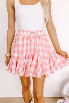 People are sure to pine away for this darling skort featuring lightweight flowy material patterned with a white and pink checkered print, an elastic waistline with a tie closure, and a relaxed silhouette that ends in a ruffled upper-thigh length hemline! Plus, these cuties have sewn in shorts! on products Measurements S : Hip 34", Inseam 2", Length 14", Waist 26". M : Hip 36", Inseam 2.25", Length 15", Waist 28". L : Hip 38", Inseam 2.5", Length 16", Waist 30". Cute Plaid Bottoms For Spring, Pink Cotton Bottoms For Brunch, Pink Ruffle Hem Bottoms For Beach, Cute Plaid Spring Bottoms, Pink Bottoms With Ruffle Hem For Summer, Pink Tie Waist Vacation Bottoms, Pink Bottoms With Ruffle Hem For Day Out, Pink Tie Waist Bottoms For Vacation, Pink Ruffle Hem Bottoms For Brunch