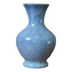 a blue vase is shown against a white background