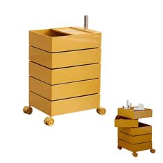 a yellow dresser with three drawers and a small drawer on the bottom, next to it's wheels