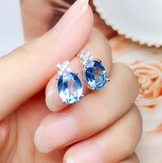 Welcome to Elegant Art Jewelry!  Material: 925 Sterling Silver Stone: Natural Blue Topaz Stone Size: 7mm*9mm Plating: Platinum plating Personalization: 9K/14K/24K/GOLD/SILVER/PLATINUM/ROSE-GOLD/WHITE GOLD. (Contact me)  Topaz Earrings, Topaz Cuff Earrings, Gold Earrings, Gold Stud Earrings, 14k Gold Earrings, 14k Gold Earrings, Round Cut Earrings, Round Cut Stone Earrings, Round Cut Studs Earrings, Topaz Drop Earrings, Topaz Studs Earrings, Topaz Studs, Topaz Earrings, Topaz Dangle Earrins, Topa Topaz Earrings For Pierced Ears, Sapphire Blue Topaz Earrings For Pierced Ears, Teardrop Blue Topaz Earrings, Blue Topaz Teardrop Earrings, Silver Blue Topaz Earrings With Brilliant Cut, Blue Topaz Round Pierced Earrings, Blue Topaz Earrings Studs, Multi-stone Blue Topaz Earrings As Gift, Luxury Multi-stone Blue Topaz Earrings