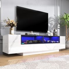 an entertainment center in a living room with a flat screen tv mounted on the wall