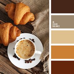 coffee and croissants on a wooden table with color swatches in the background