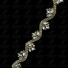 the side view of a bracelet with crystal stones and leaves in gold tone on a black background