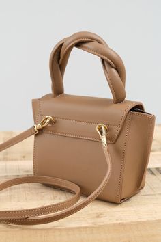 The Montalbano Mini Handbag. With a twisted handle, this mini bag is the perfect accessory to hold your daily essentials. It can be worn cross body, or on your arm with the detachable body strap. With canvas lining and a leather exterior, this mini handbag is the perfect addition to your fall wardrobe. Versatile Brown Satchel For Evening, Versatile Brown Evening Satchel, Trendy Brown Box Bag With Handle Drop, Brown Tote Box Bag With Adjustable Handle, Brown Top Handle Box Bag With Handle Drop, Brown Box Bag With Handle Drop Top Handle, Brown Shoulder Bag With Adjustable Handle For Evening, Brown Box Bag With Handle Drop And Top Handle, Brown Evening Shoulder Bag With Adjustable Handle