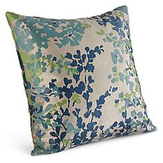 a blue and green pillow on a white background