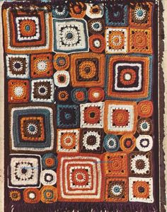 an afghan is shown with squares and circles in the center, as well as fringes