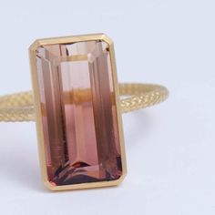 Description One-of-kind 18k yellow gold ring with an earthy brown and pink bi-color Tourmaline set in a vertical setting. The pink and brown is a perfect balance to create the perfect feminine color that's not too cute or too sweet, like a glass of Portes you drink next to your fire place. This ring is in a rope design, adding detail to every part of the ring. Details 18k Yellow GoldBi-color Tourmaline – 5.97ct (Approximately 7.6mm x 12.1mm x 5.7mm) Made in Japan *Please note that due to the nat Luxury Gold Tourmaline Rings, Elegant Gold Tourmaline Rings, Elegant Tourmaline Rings In Yellow Gold, Elegant Yellow Gold Tourmaline Rings, Modern Gold Tourmaline Rings, Gold Tourmaline Ring In Fine Jewelry Style, Gold Tourmaline Rings In Fine Jewelry Style, Gold Tourmaline Ring Fine Jewelry, Gold Tourmaline Rings