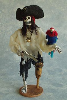 a statue of a pirate holding two parrots