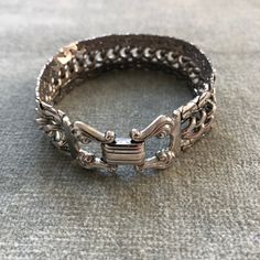 "This bracelet has some weight to it. The curb chain at the center is flanked by snake chains which are soldered to it so the piece moves as a sinuous whole. The clasp belies the more modernist look of the chain, with it's lyre shaped finials holding the fold over closure. The piece measure 7 3/4\" long by 3/4\" wide.  I'm happy to ship internationally but costs have risen so dramatically I can no longer ship worldwide for $12. If you are outside of the US and want to make a purchase. Let me kno Metal Cuban Link Bracelet With Curb Chain, Silver Metal Cuban Link Chain Bracelet, Cuban Link Bracelet With Curb Chain In Metal, Formal Silver Cuban Link Bracelet With Curb Chain, Metal Curb Chain Link Jewelry, Metal Curb Chain Jewelry, Silver Adjustable Snake Chain Bracelet, Silver Bracelets With Rectangular Chain Links, Modern Metal Chain Bracelet With Hooks And Links