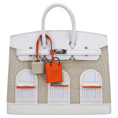 Mightychic offers a limited edition Hermes Birkin Faubourg 20 Sellier bag featured in Neige (Snow). This rare treasure is a crowning jewel to any Hermes collector. Exquisite craftmanship created in: Matte Beton Matte Alligator White Swift and Clemence leather. The window awnings and clochette are Orange H Swift leather. Three window panels are Bleu Brume Chevre Mysore leather and the trim is Craie Swift leather. Precision details create the slight 3-D effect of the Hermes flagship on 24 Rue du F Rare Birkin Bag, Hermes Rare Bag, Tas Hermes Limited Edition, Rare Hermes Bags, Hermes Limited Edition Bag, Hermes Birkin Limited Edition, Paul Lacamera, Birkin Collection, Hermes Limited Edition