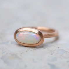 An elongated lozenge shaped white opal is set into matte rose gold. Band width 2.2 mm. This ring is able to be made with other gemstones and in other metals. Sarah Gardner, Rose Gold Band, Central African, Instagram Icons, Opal Ring, Caicos Islands, White Opal, Fine Jewellery, Gold Band