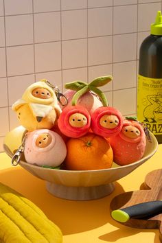 a bowl filled with fruit sitting on top of a table