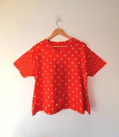 Cute vintage 80s retro top. In bright red soft stretchy jersey and printed with white polka dots and stars. Has a line of two pretty pink, blue, red and orange gemstone Ryans belt stars at the front & stitched v neckline. CONDITION Excellent with no flaws noted. LABEL None MATERIAL No labels so can't be sure but feels like cotton.  SIZE XL (UK 12-14) Measurements taken flat with chest and hips doubled to give overall size: * Chest: 46" * Hips: 48" * Back length collar edge to hem: 22" * Sleeve l Retro V-neck T-shirt For Summer, Vintage V-neck T-shirt For Spring, Vintage V-neck Top With Relaxed Fit, Retro V-neck T-shirt For Spring, Polka Dot Cotton T-shirt With Short Sleeves, Cotton T-shirt With Polka Dot Pattern And Short Sleeves, Fitted Star Print Summer Tops, Fitted Star Print Tops For Summer, Retro V-neck Relaxed Fit Top