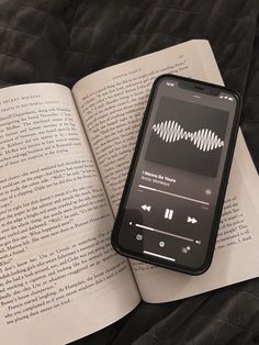 an open book with audio player on top of it