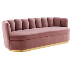 a pink velvet couch with gold legs