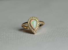 Opal Engagement Ring Gold Engagement Ring Pear by capucinne Elegant Teardrop Opal Promise Ring, Elegant Teardrop Opal Ring As Gift, Teardrop Opal Diamond Wedding Ring, Teardrop Opal Ring For Wedding, Elegant Teardrop Opal Ring, Elegant Teardrop Opal Ring For Wedding, Elegant Teardrop Opal Ring Gift, Formal Pear-shaped Yellow Gold Opal Ring, Gold Pear-shaped Opal Ring For Wedding