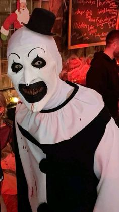 a person in a white and black clown costume