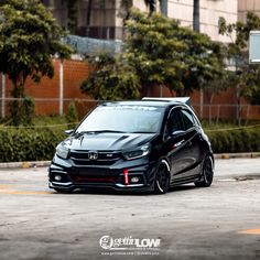 a black car parked in an empty parking lot