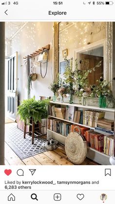 an instagram page with flowers and books on the shelf in front of a mirror