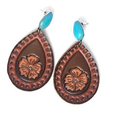 two brown and blue earrings with flowers on them