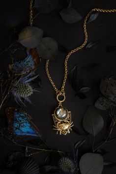 "This piece features a crab and a labradorite 'full moon' on a shield-style pendant. The constellation of Cancer, represented by a crab, is ruled by the moon. Cancer is shrouded in dark, feminine mysteries which can be accessed by emotions and spirit and not by thought.   26\" chain 1.5\" pendant ~Antique gold over brass and pewter ~Labradorite" Crab Jewelry, Crab Earrings, Short Necklaces, Indie Jewelry, Witchy Jewelry, Dark Feminine, Feather Jewelry, Antique Jewellery, Full Moon