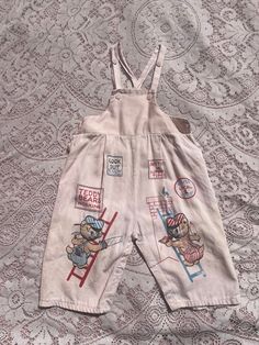 CUTE 1950s overalls. Light pink cotton with "Teddy Bears Working". Button closures. Diaper snaps. Good vintage condition. Overall wear throughout. Elastic in the back is worn. estimate size 12-18 months Waist 20 inches  length from top of bib to hem 18 inches. Straps have two different snaps for adjustment  PLEASE NOTE, this is a vintage item that has been worn and loved. I do my best to note all flaws Vintage Cotton Overalls For Playtime, Pink Cotton Bib Front Overalls, Pink Cotton Shortalls With Pockets, 1950s Overalls, Kids Overalls, Vintage Baby Clothes, Fashion Journals, Pink Cotton, Vintage Baby