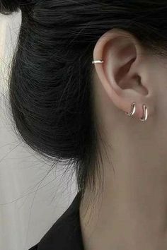 a close up of a person's ear with two piercings on the side